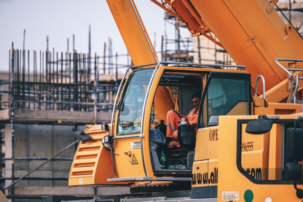 Man in heavy equipment cab on construction site