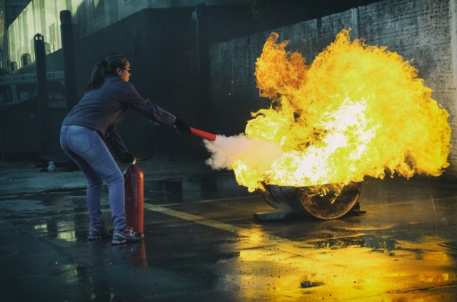 women-putting-out-fire-with-extinguisher-emergency-preparedness