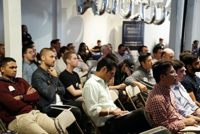 A group of people listening to a presentation.