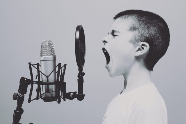 boy-screaming-into-microphone