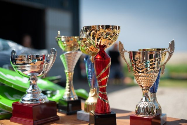 trophy-cups-on-wooden-table