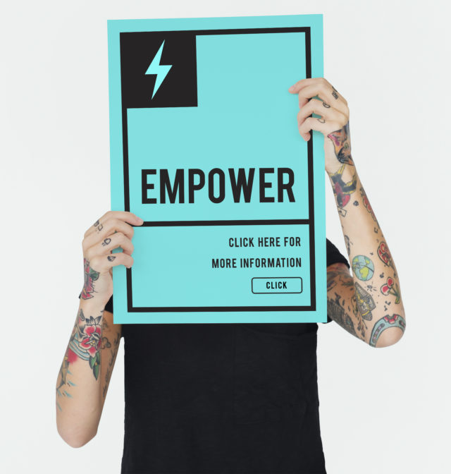man-holding-sign-reading-empower