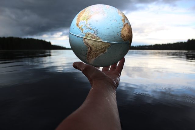 Hand holding a globe of Earth