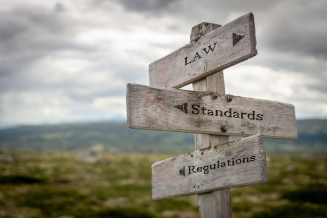 law-standards-regulations-on-wooden-sign-outdoors